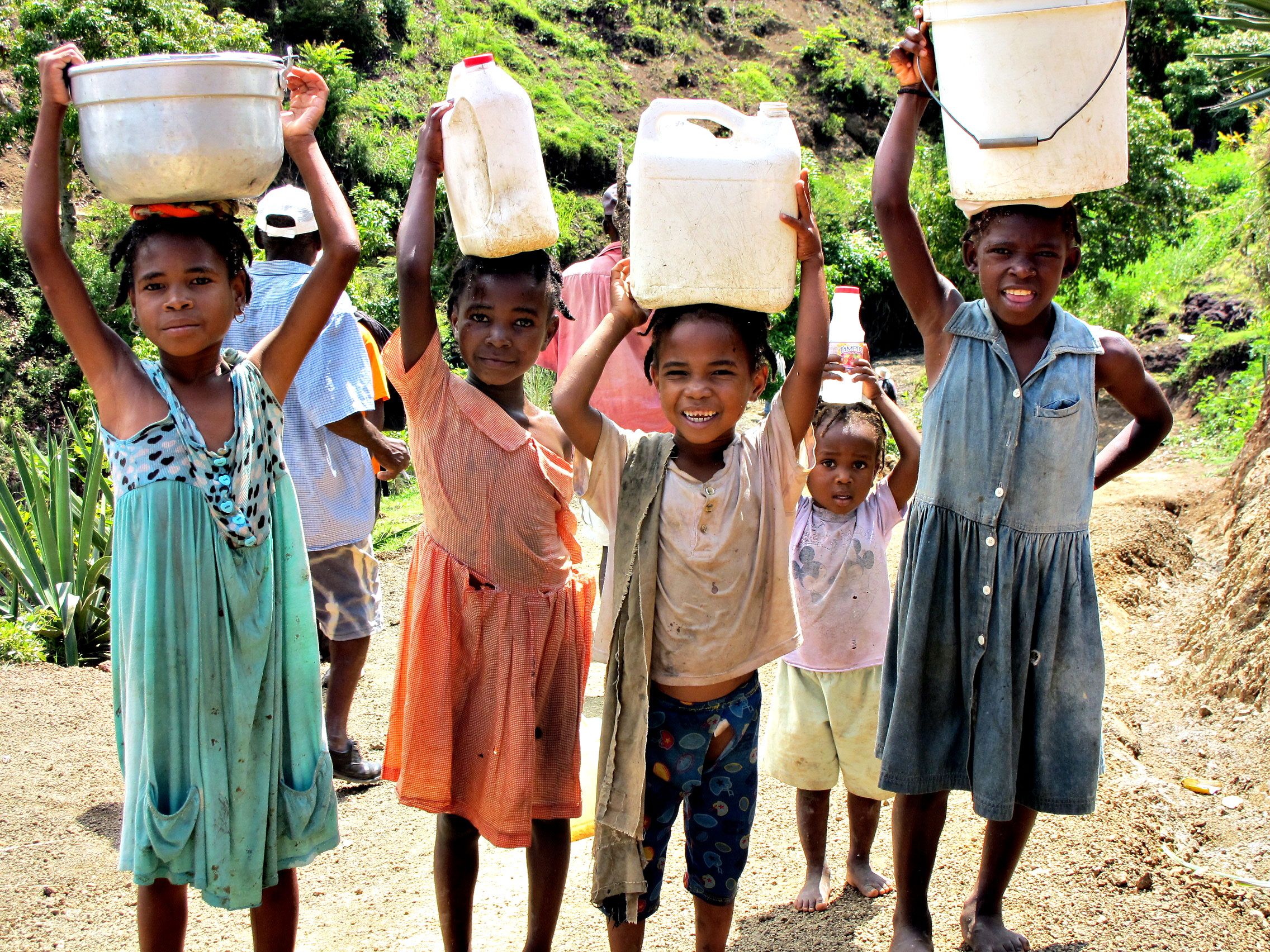 children carrying jugs of water
