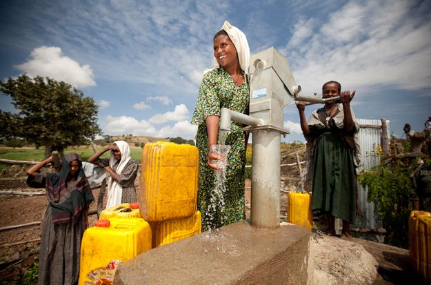 women getting water from well