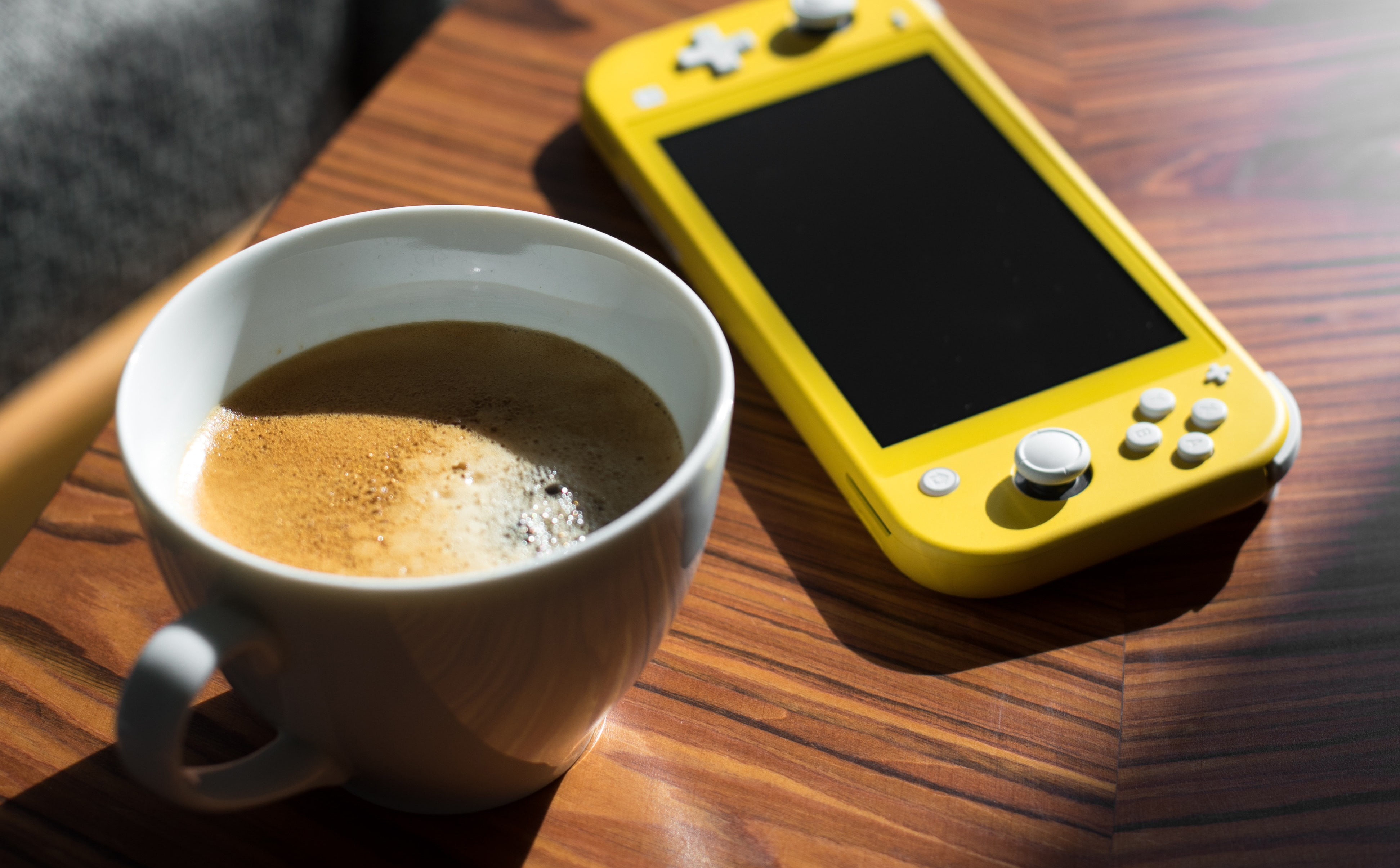 Nintendo Switch Lite with cup of coffee
