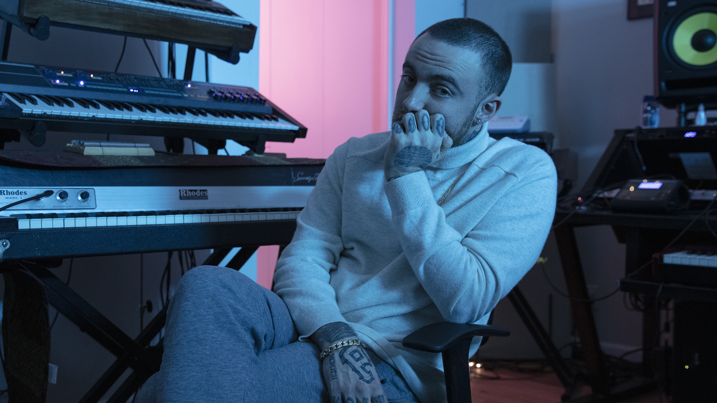 Miller sitting at a keyboard in his music studio
