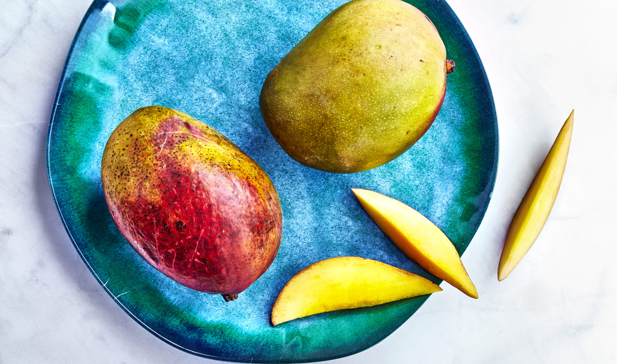 Mangos on rustic blue plate