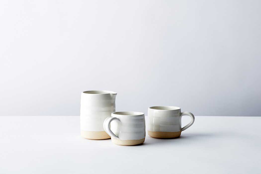 two mugs and a creamer set