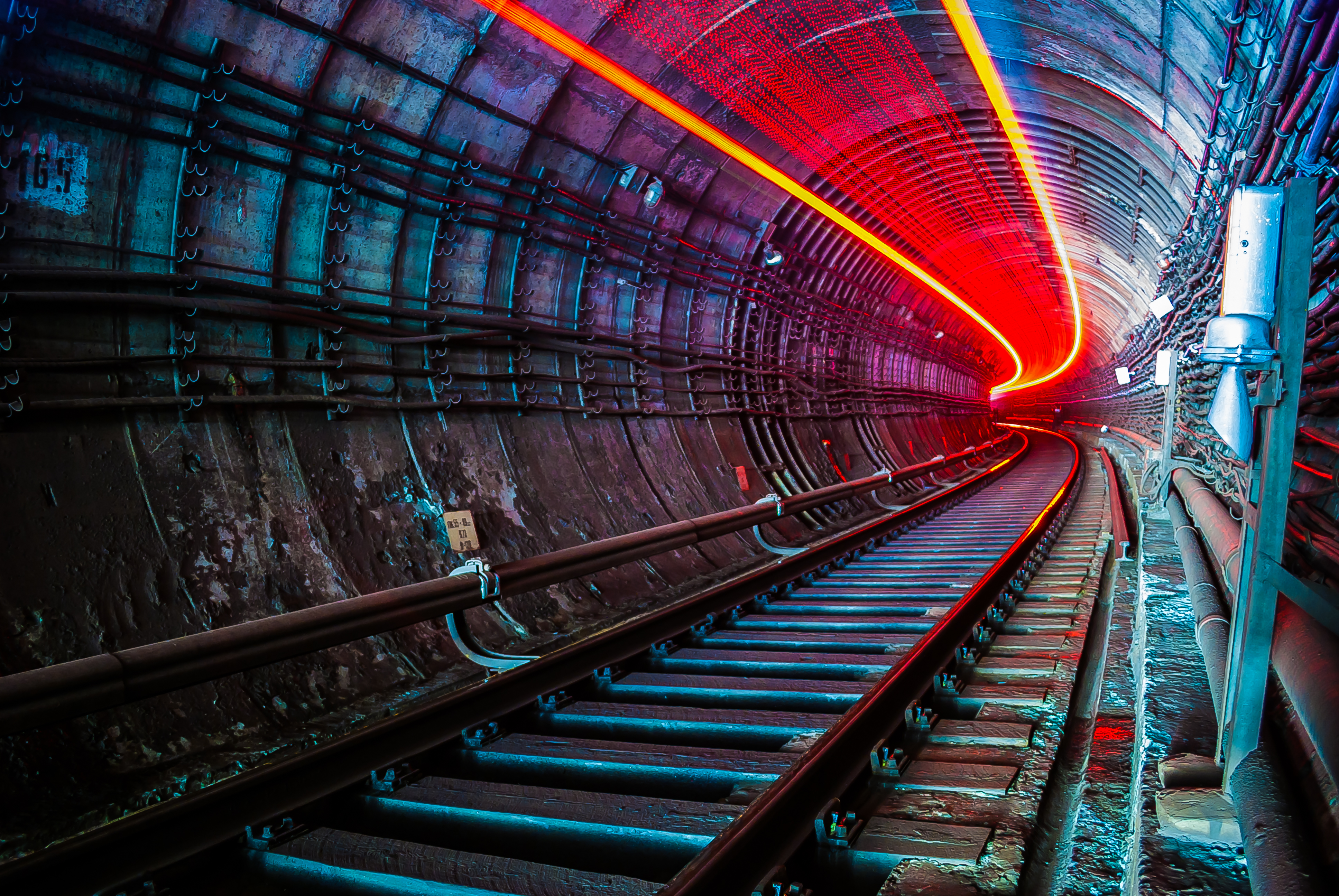 Long exposure photo of a subway tunnel with a passing subway train