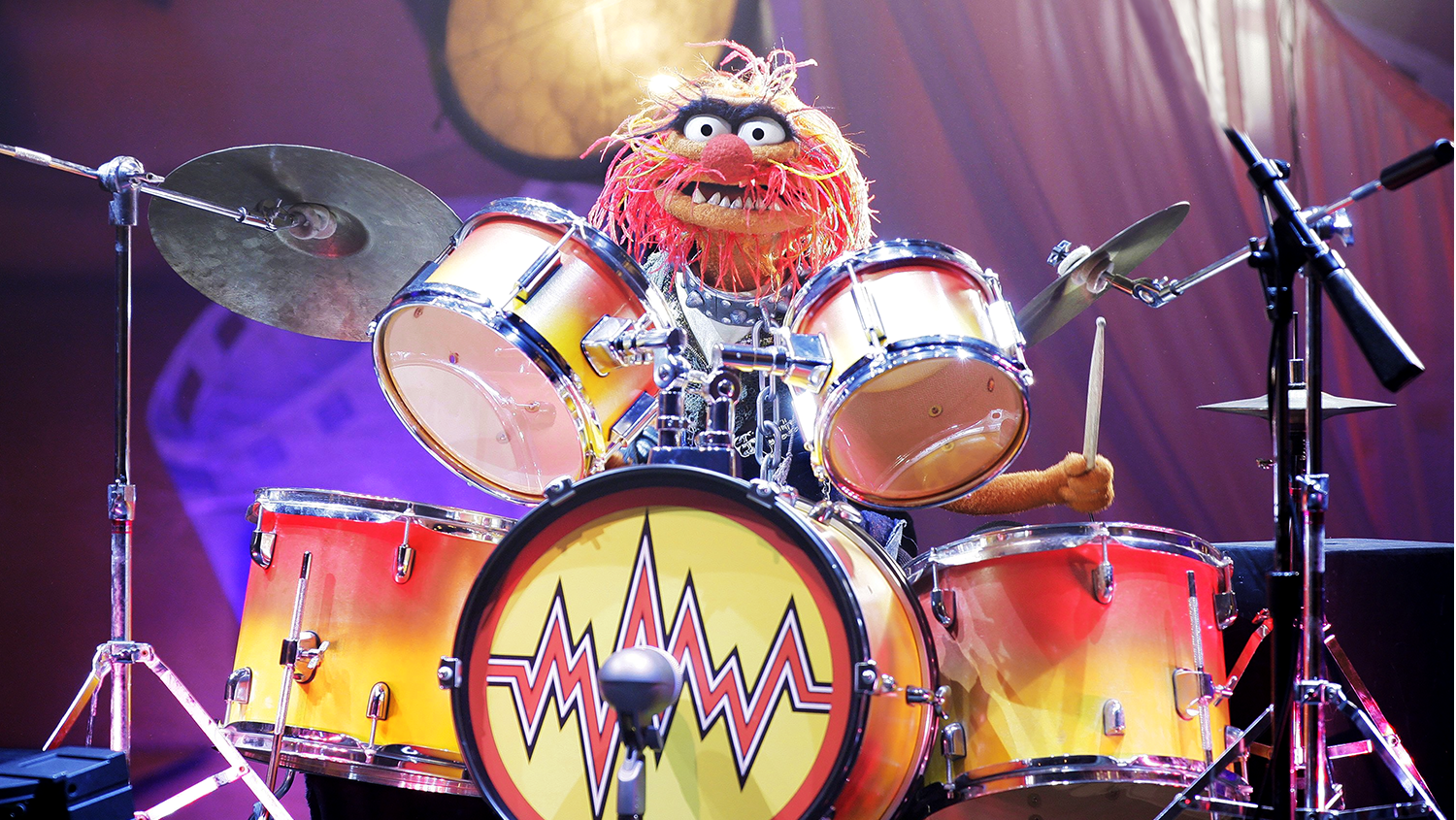 Animal from The Muppets playing the drums