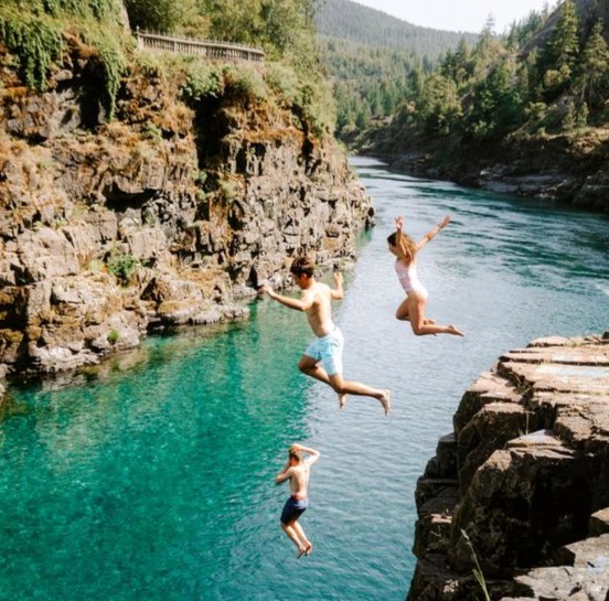 people jumping off a cliff