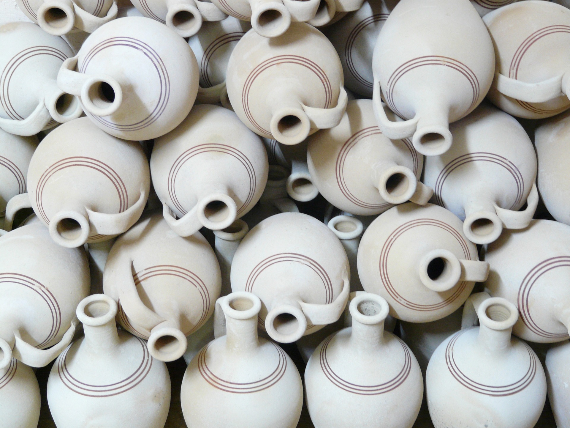 A stack of white pottery pots