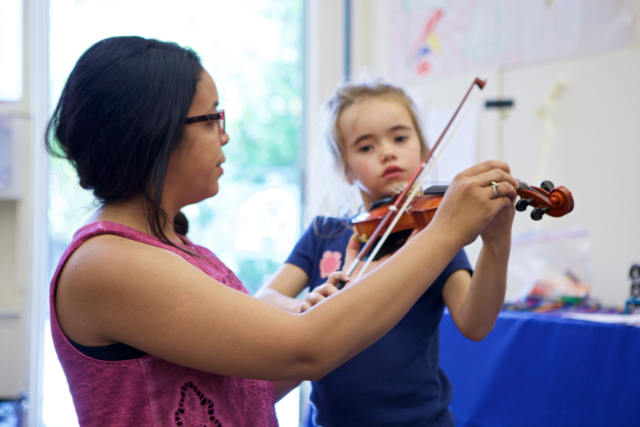 Skarli teaching violin