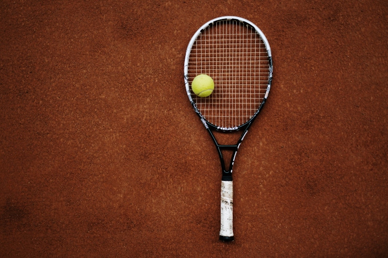 A tennis racket on clay surface