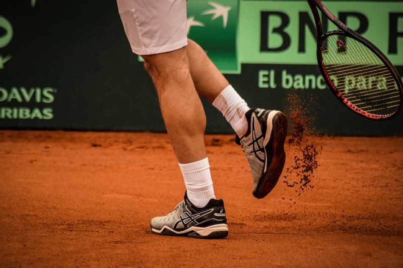 Tennis player playing tennis on clay court