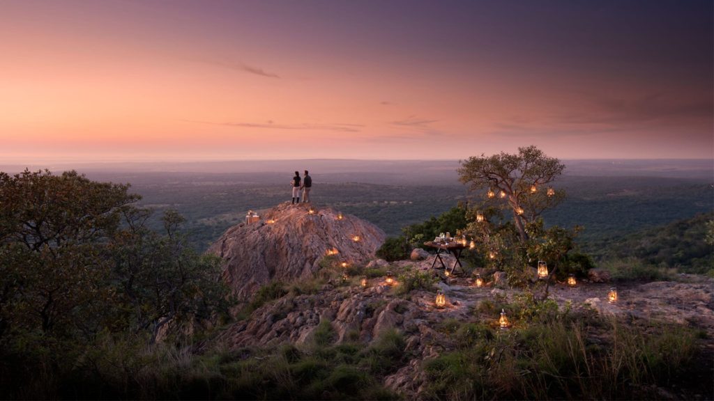 Couple standing on rocks overlooking the landscape