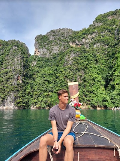 boy sitting on a boat in Phi Phi Island
