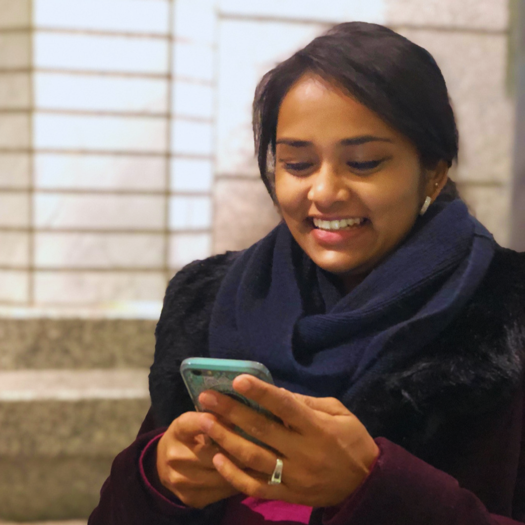 Image of Aish checking her phone