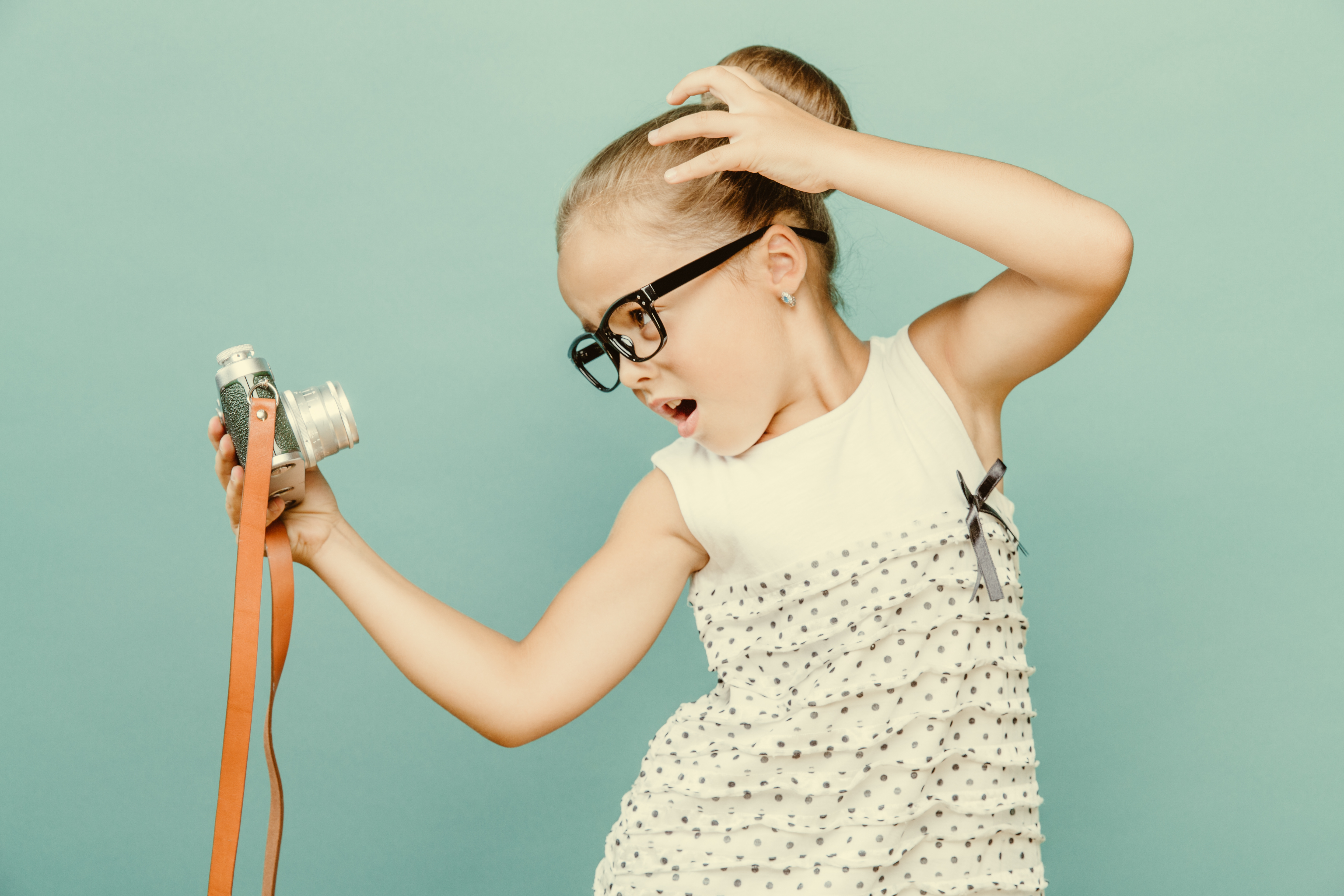 young girl posing with camera