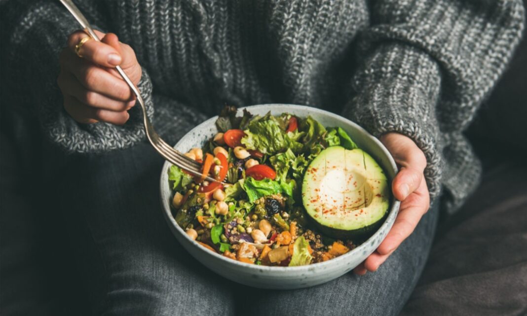Girl eating a vegan bowl