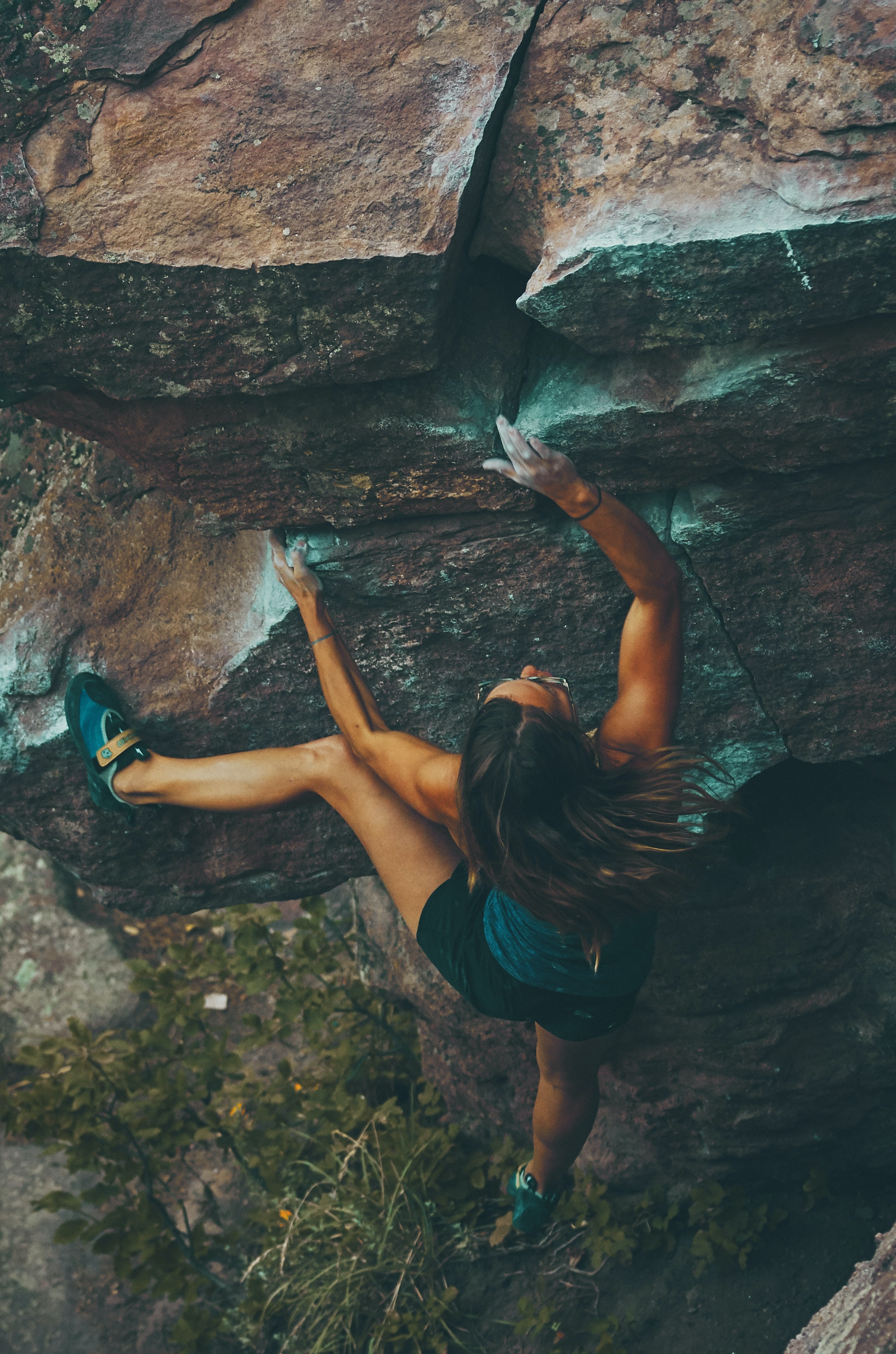 Woman bouldering an outdoor rock formation