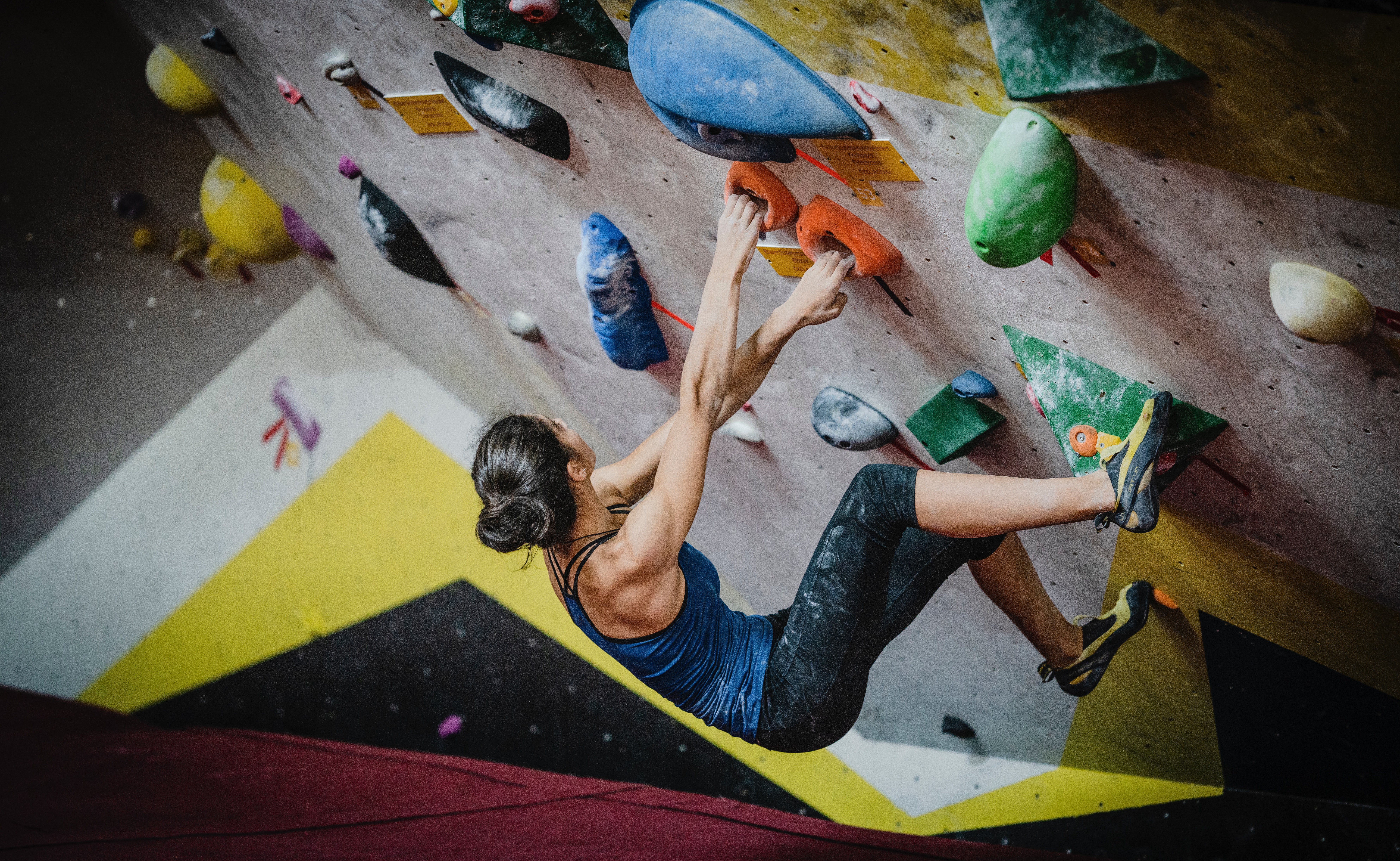 Woman climbing an indoor rock wall
