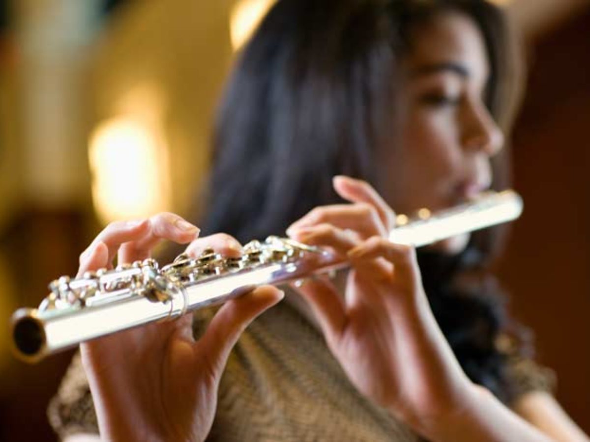 Side view of a person playing flute