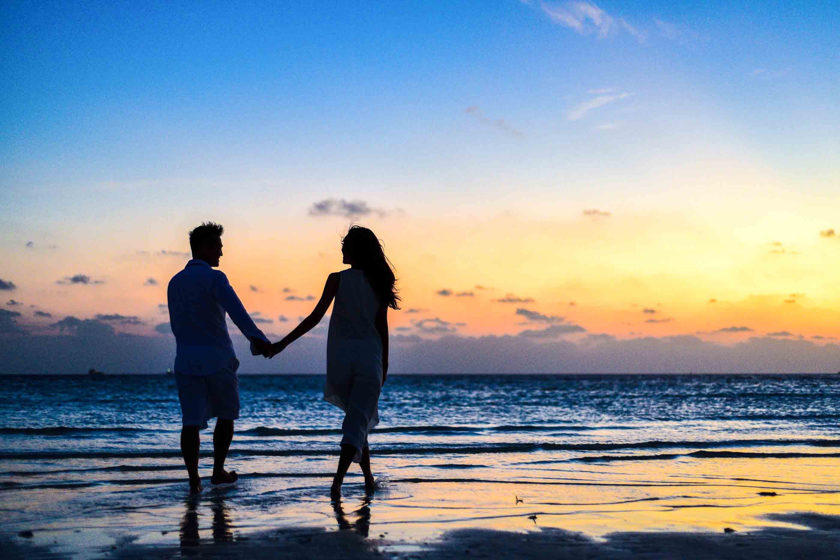 couple holding hands at the beach