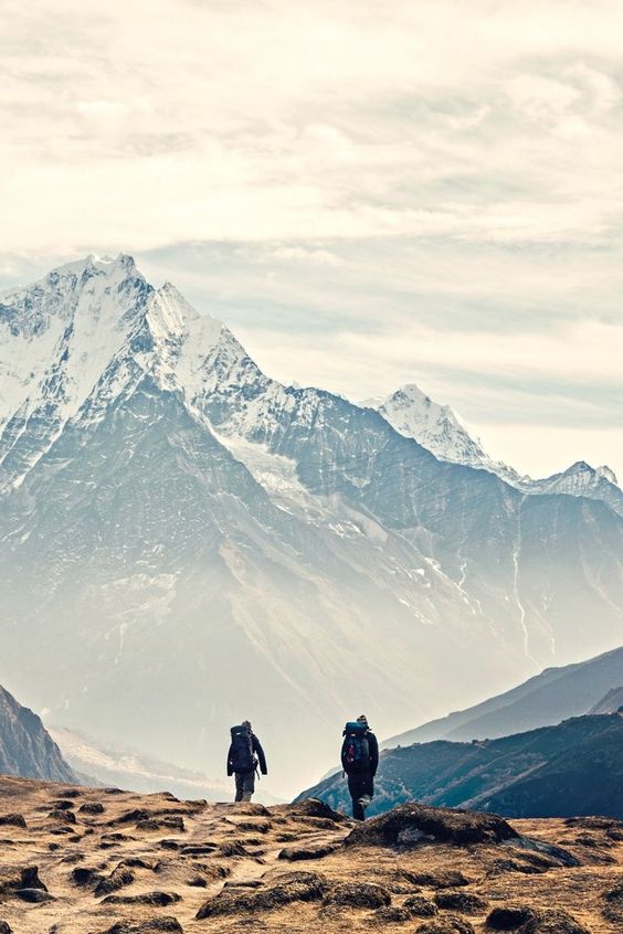 Two hikers walking on a mountain
