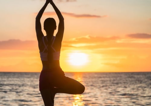 Women doing yoga at the beach