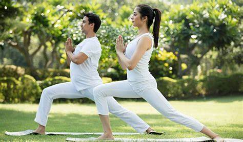 Man and woman practing yoga outside