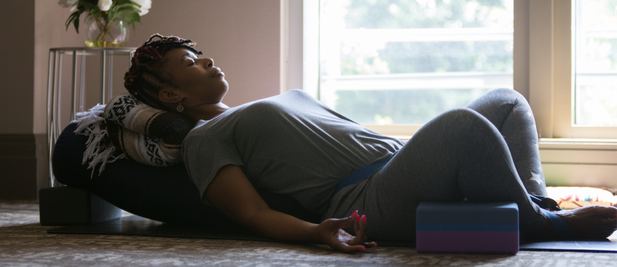 woman practicing restorative yoga