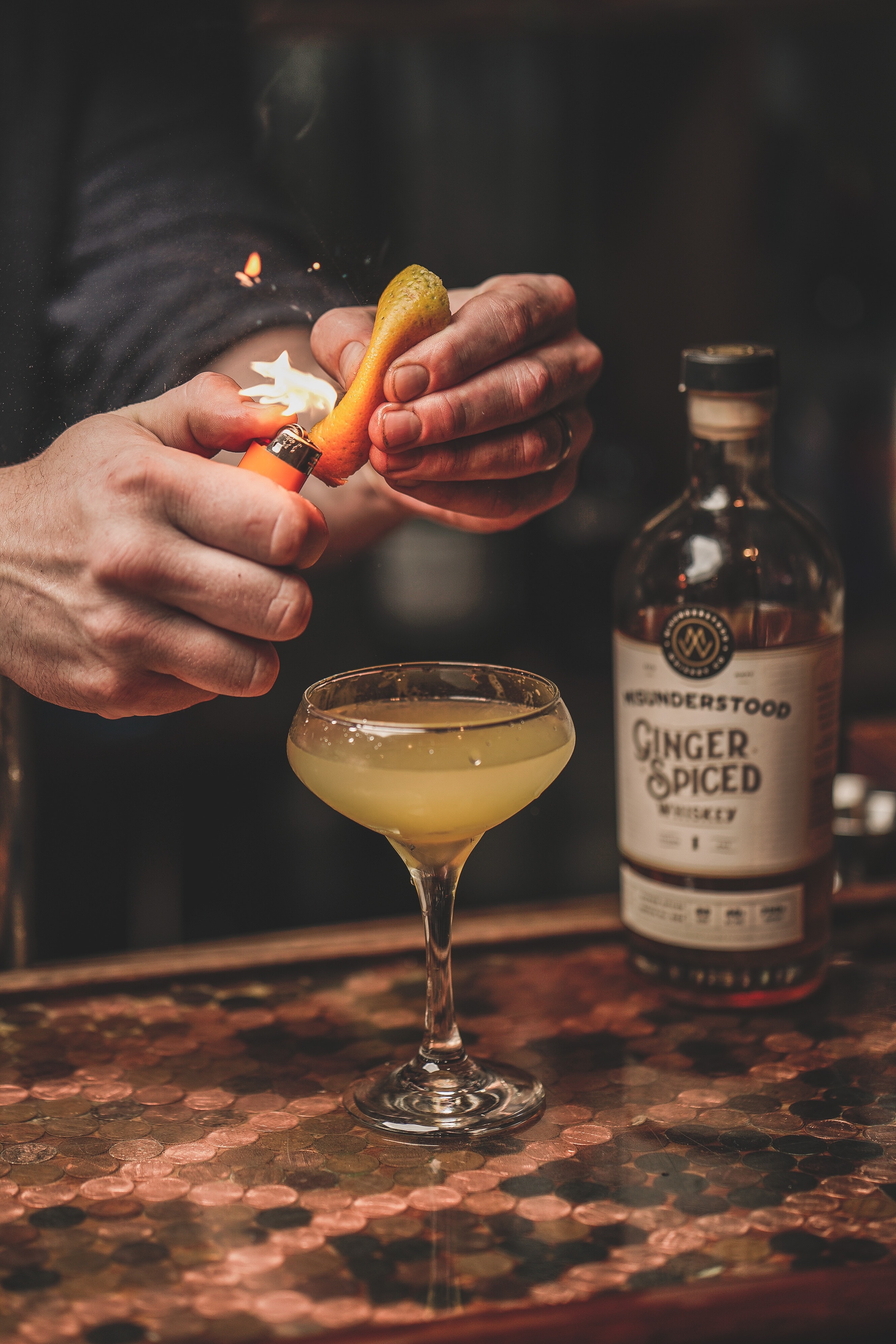 flaming citrus oils over a whisky cocktail