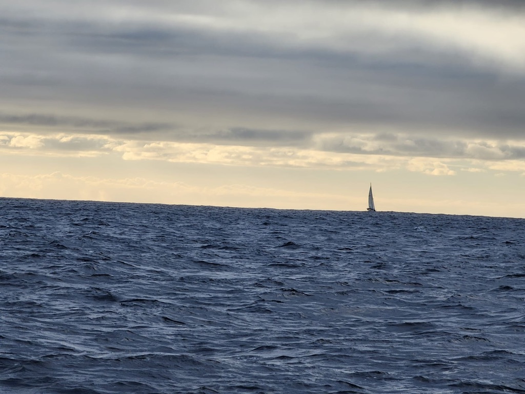 blue ocean with a boat in the horizon