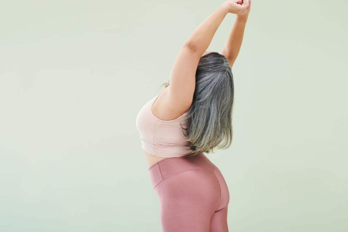Person stretching with arms above their head