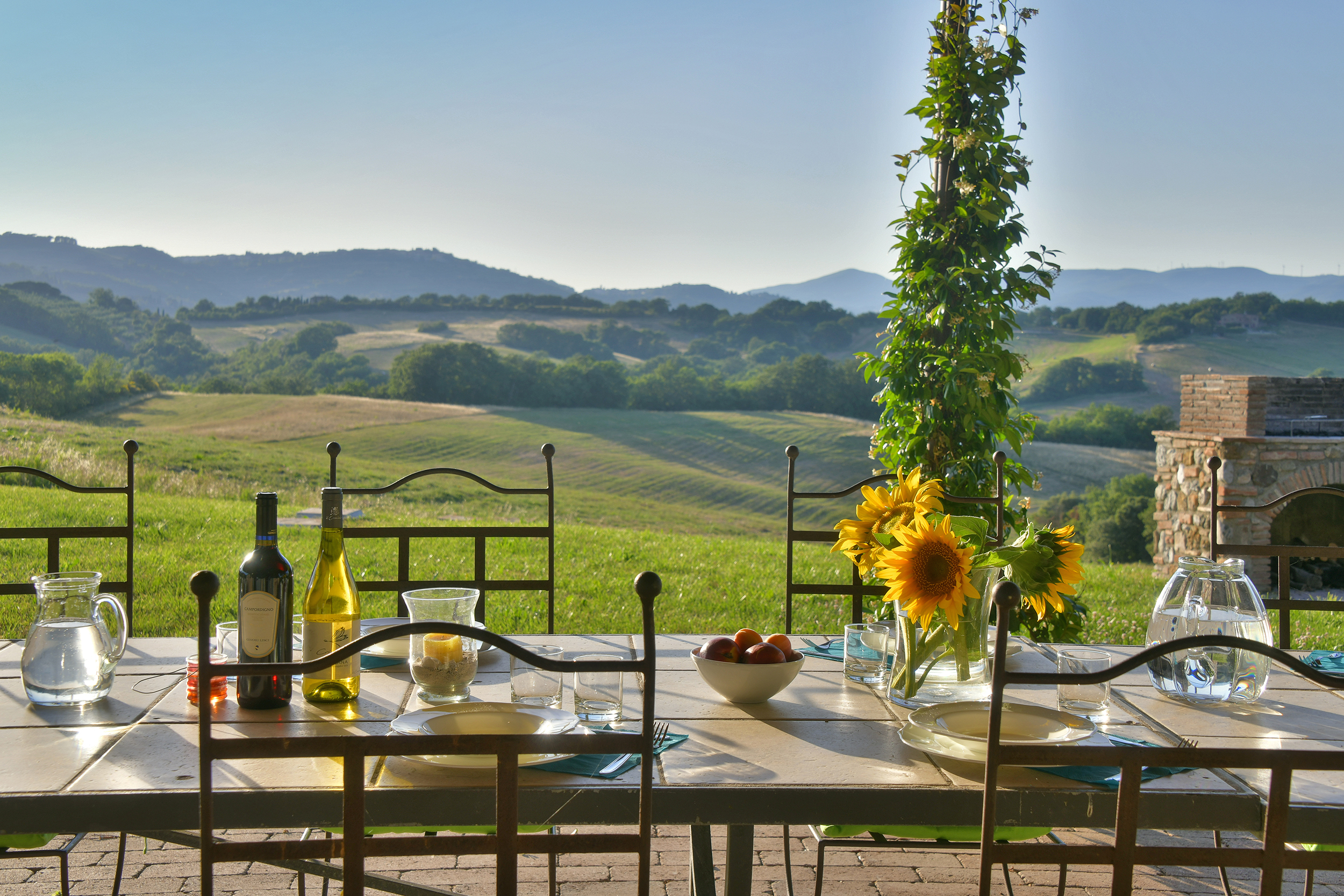 table with food with a view to a tuscan landscape