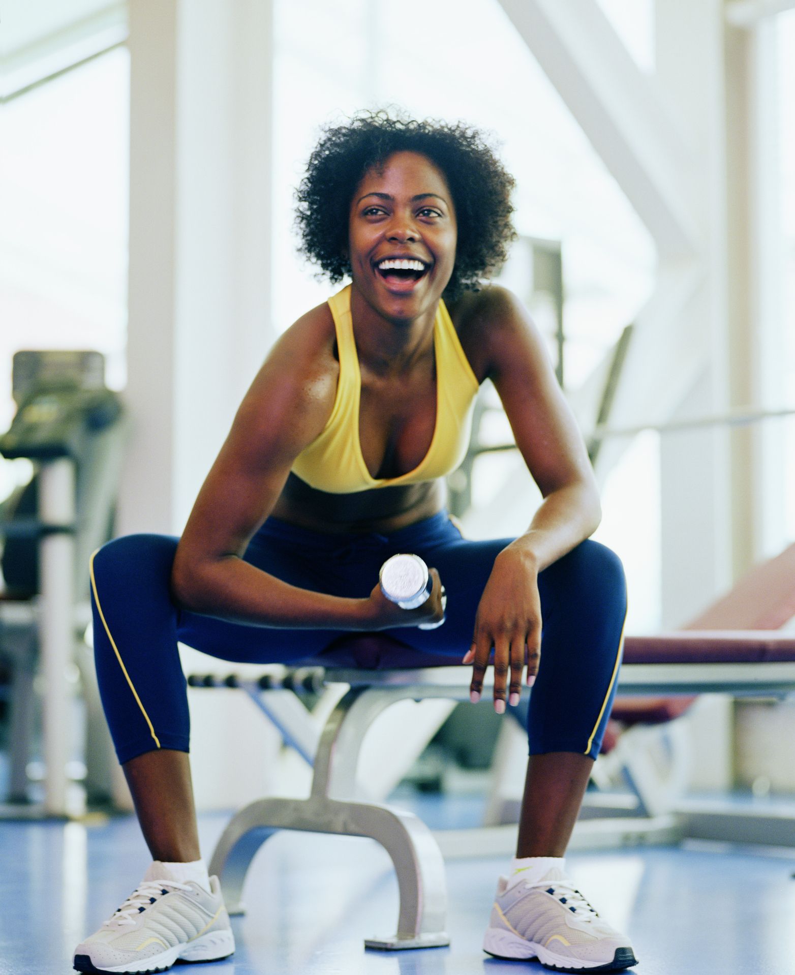 Woman lifting dumbbell in a gym