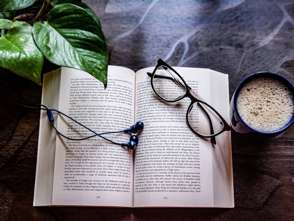 Open book with spectacles and cup of coffe
