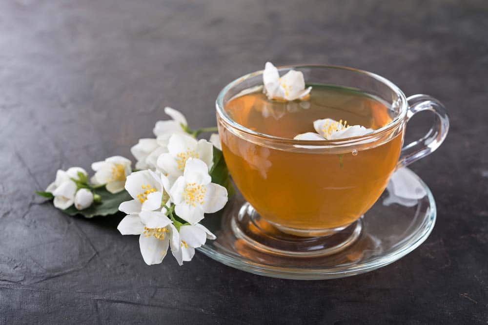 Jasmine Flowers and Green Tea in a cup