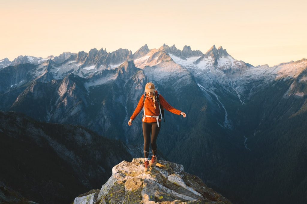 Woman standing on peak of mountain