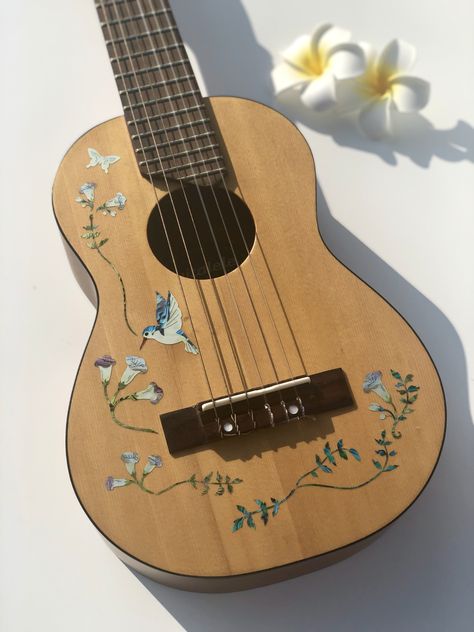 image of acoustic guitar with white flower design