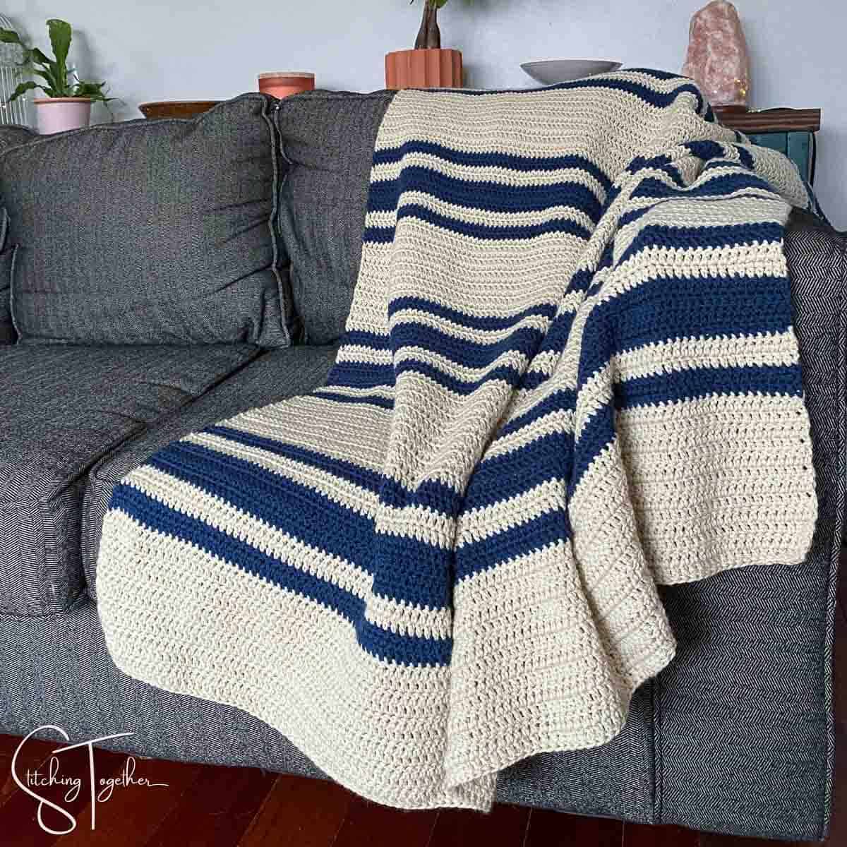 crochet blanket with blue stripes on couch