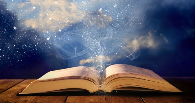 open book on wooden table with glitter overlay