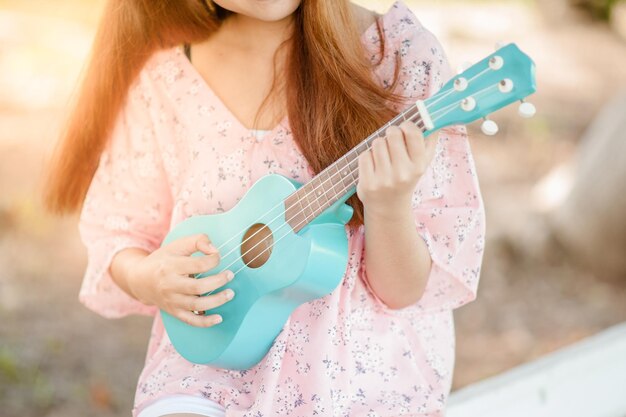 woman playing the ukulele
