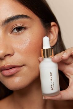 a woman holding a skin care product