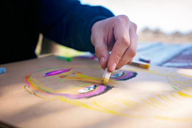 artist drawing a portrait in oil pastel