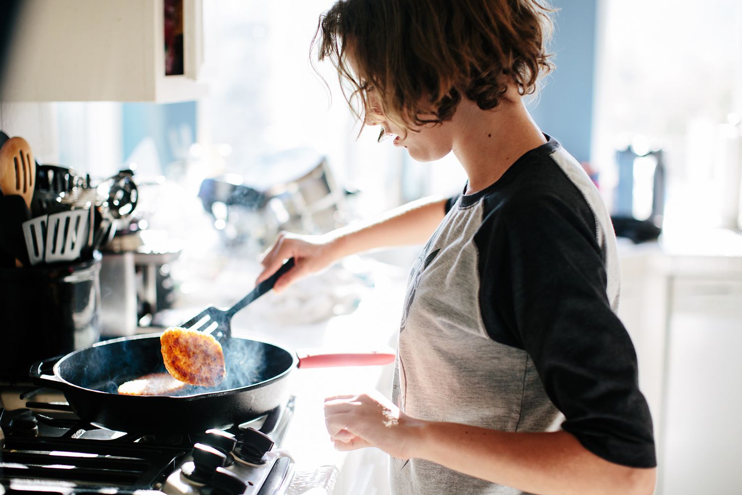 A woman wooking over the stove