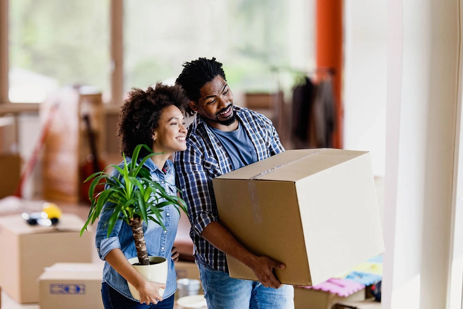 a woman sits next to moving boxes
