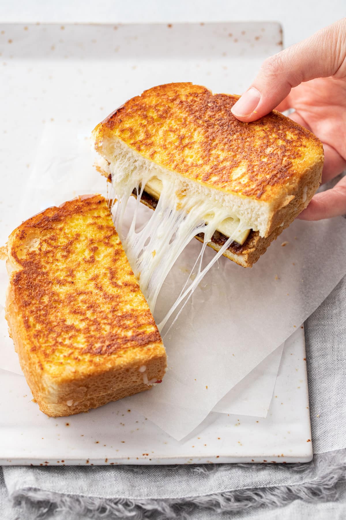 Grilled cheese sandwich being pulled apart
