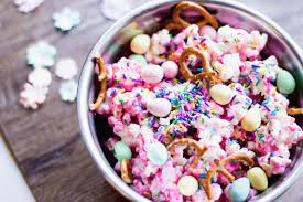 Popcorn in a bowl sitting on a wooden table