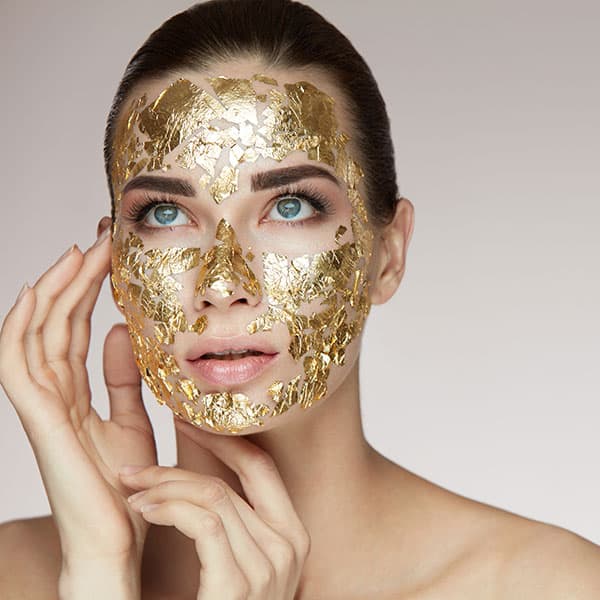 model with a gold face mask