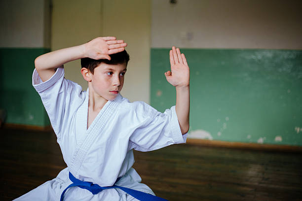 Boy practising karate doing a kata