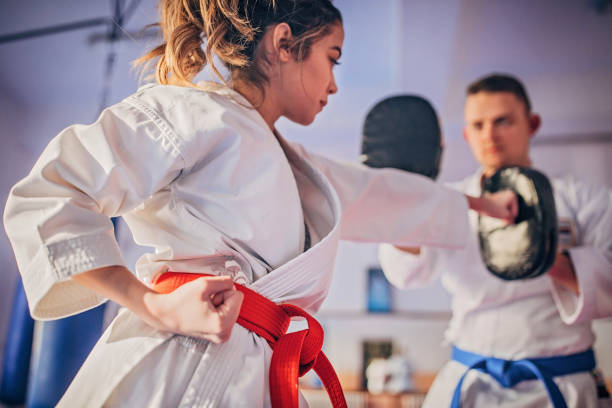 Girl practising karate using pads