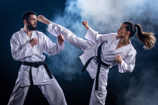Man and woman in karate combat