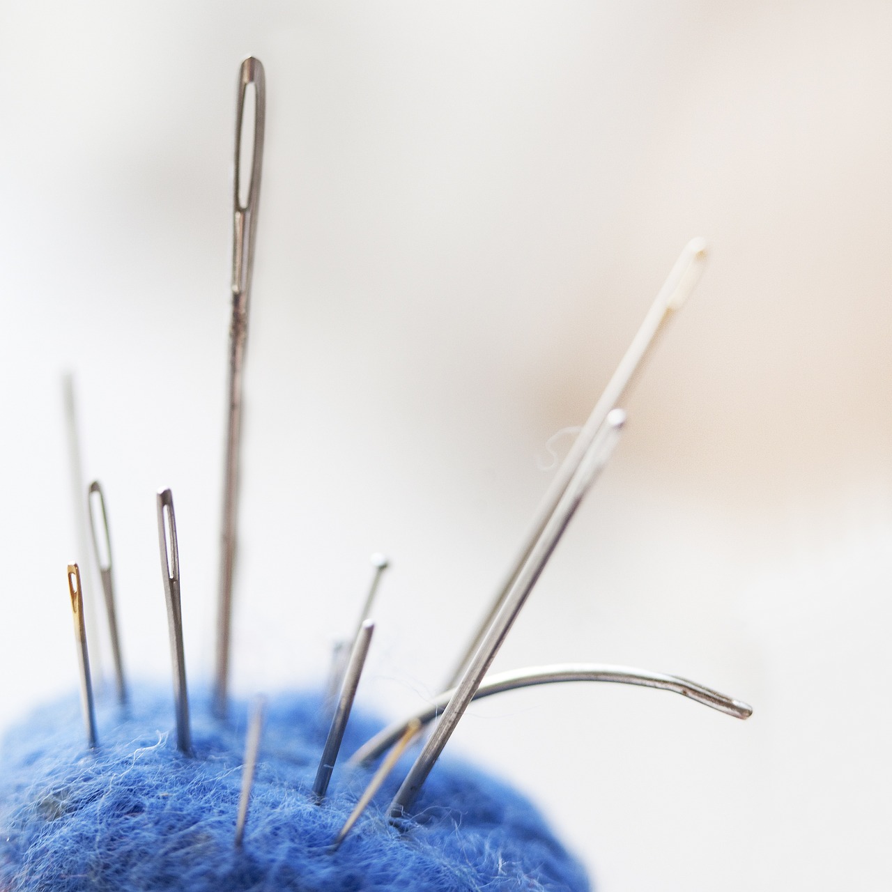 close-up of embroidment needles in a pin cushion