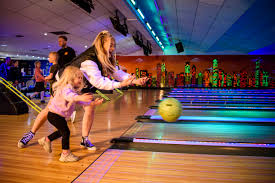 Throwing bowling ball with friends and family
